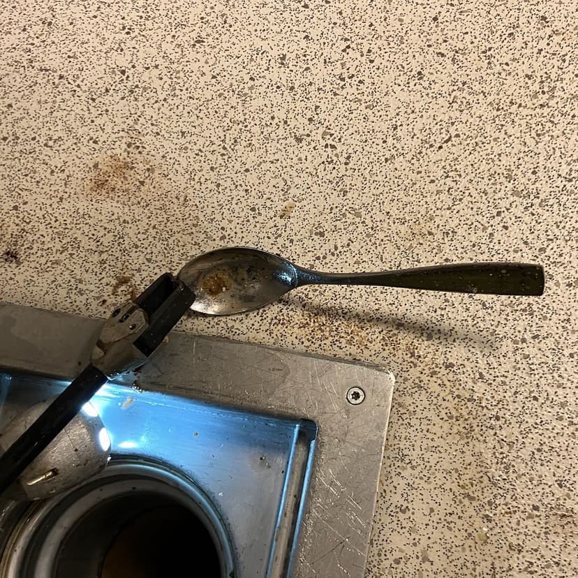 Bilde som viser spiseskje som er hentet ut fra avløpsrørene